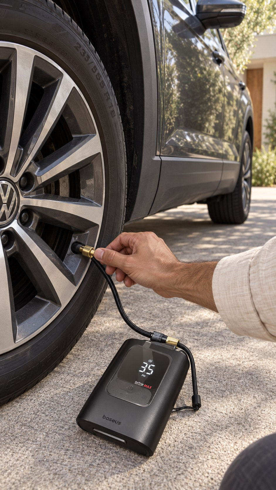 Tire inflator beside the car wheel